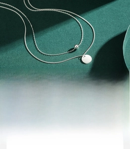 Polished 925 silver double-layered necklace showing macro details of the round pendant