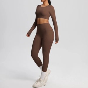 Detail view of high-waist coffee yoga leggings with side pockets and long sleeve crop top
