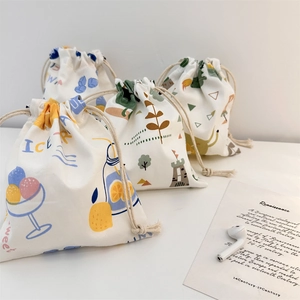 Close-up of small drawstring storage pouches with Nordic illustrations for accessories