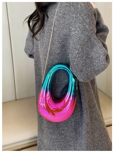 Detail of pink blue green gradient acrylic clutch with round handle and metal chain strap