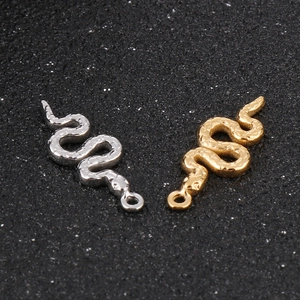 Gold and silver snake pendants with scale texture and small hanging rings for DIY jewelry