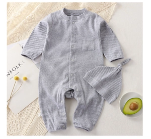 Detailed view of grey ribbed cotton baby bodysuit and knotted hat on lace background