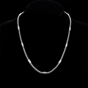 Polished silver stainless steel cylinder link chain necklace on black velvet bust