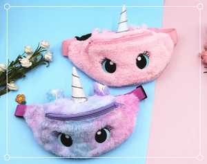 Detail view of plush unicorn waist bags showing embroidered eyes and soft texture