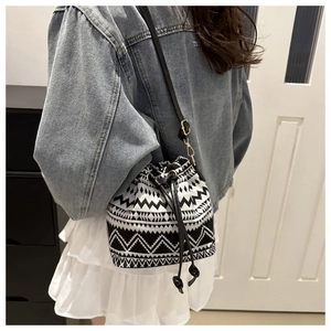 Ethnic bucket bag with black and white geometric patterns and adjustable shoulder strap