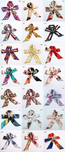 Detailed collection of floral and geometric print silk neckerchiefs and hair ribbons