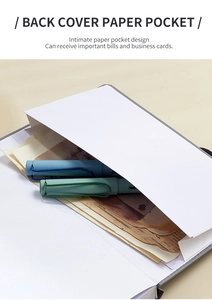Detail view of the back pocket in an undated planner containing notes and a pen