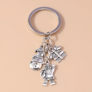 Detailed view of silver alloy Christmas keychain with snowman, Santa, and gift box charms