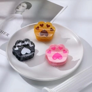 Three cute cat paw acetate hair claws in amber, marble, and pink with heart patterns