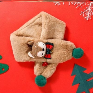 Close-up of plush brown Christmas scarf with green pom poms and cute reindeer design