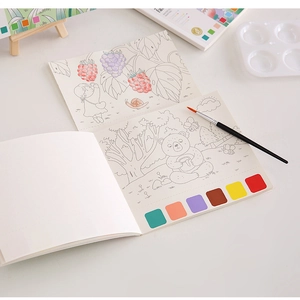 Close-up of portable watercolor painting book with built-in pigments and brush for kids