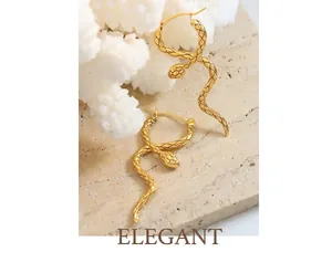Detailed macro view of gold snake earrings featuring intricate scale textures and coiled design