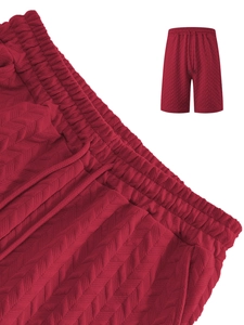 Close-up of deep red jacquard waffle knit shorts featuring elastic waistband and drawstring