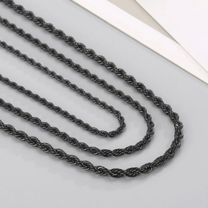 Detailed macro shot of the black titanium steel twisted rope chain with spiral texture