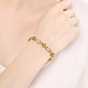 Minimalist 18k gold plated stainless steel Cuban link twist bracelet on woman's wrist