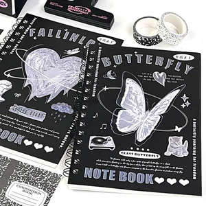 Close-up of black butterfly themed spiral notebook with aesthetic stationery layout