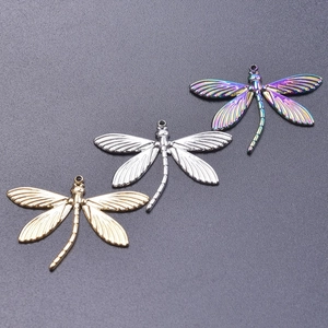 Detail view of dragonfly charms in gold, silver, and rainbow finishes for DIY jewelry