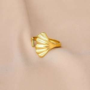 Elegant gold-plated ginkgo leaf open ring with adjustable band on beige fabric
