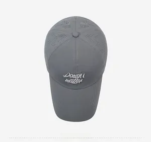 Detail of dark gray baseball cap with heart-shaped laser cutouts and white embroidery