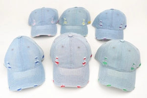 Top view of vintage distressed denim baseball caps with colorful stitching and 1989 embroidery