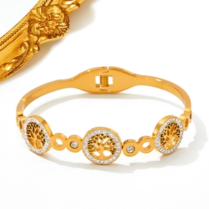 Gold plated stainless steel hollow Tree of Life bangle with white rhinestone inlay