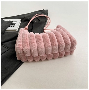 Borsa rosa in peluche con trama a coste e tracolla su un blazer grigio