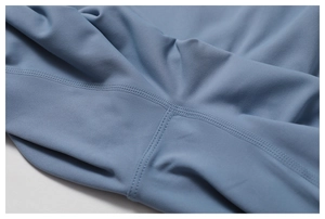 Detailed macro view showing professional flatlock stitching on high-stretch yoga fabric
