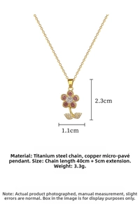 Macro view of gold flower necklace with pink crystals and adjustable titanium steel chain