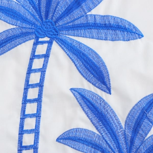 Vacation two-piece set featuring white fabric with blue coconut tree embroidery detail