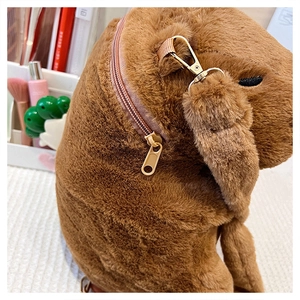 Detail view of plush Capybara backpack featuring durable metal buckles and zipper closure