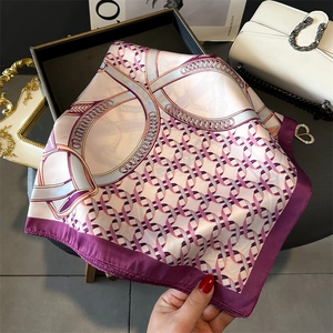 Detail view of pink and purple chain pattern silk scarf with elegant satin finish