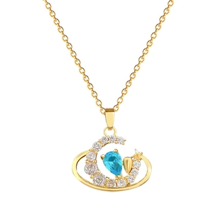 Elegant gold crescent moon necklace with blue teardrop stone and sparkling zircons