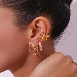 Detail view of 18K gold plated stainless steel hammered texture hoop and stud earring set