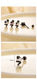 Macro detail of heart zircon stud earring with black snake-shaped spiral steel base