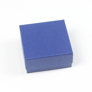 Macro shot of dark blue square jewelry box with textured finish for rings and earrings