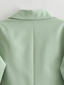 Detail view of the back collar and seam stitching on a mint green blazer for women