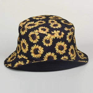 Detail of sunflower print on black cotton bucket hat showing fabric texture and vibrant pattern