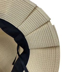 Elegant beige straw sun hat with layered brim detail and adjustable interior strap