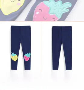 Detail view of navy blue cotton leggings with strawberry embroidery and full product view
