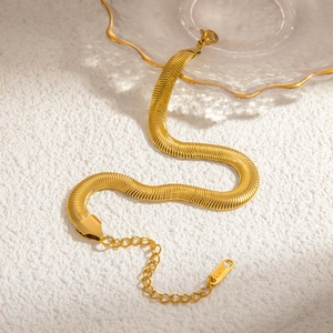 Close-up of a gold stainless steel herringbone snake chain with an adjustable extender