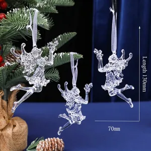 Three acrylic fairy ornaments with wings hanging on Christmas tree with white ribbons