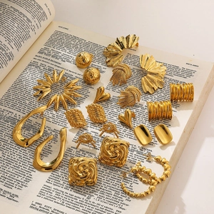 Detailed flat lay of golden textured knot earrings and irregular geometric studs