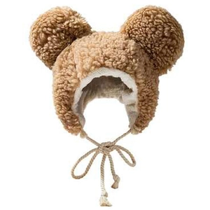 Detail of plush teddy fleece texture and windproof straps on a cute brown baby bear hat