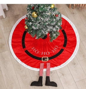 Detail of red Santa Claus tree skirt with belt buckle and cute plush legs on wood floor