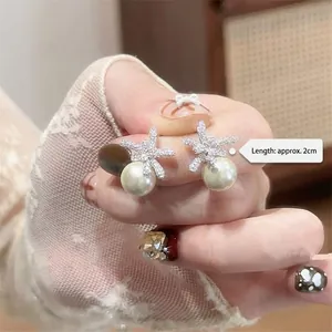 Elegant silver flower stud earrings with zircon crystals and hanging white pearl, 2cm size