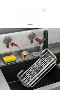 Detail of stainless steel kitchen sink rack with drainage holes and towel bar