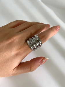 Macro shot of a chunky multi-layer wavy silver titanium steel ring for women