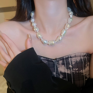 Detail of baroque pearl necklace with large irregular white pearls and iridescent luster