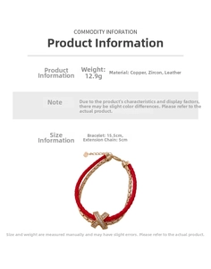 Detail view showing a double-layer red leather and gold chain bracelet with zircon X charm