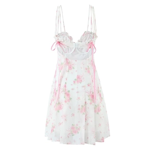Detail of pink rose floral print on white sundress with adjustable back ribbon ties